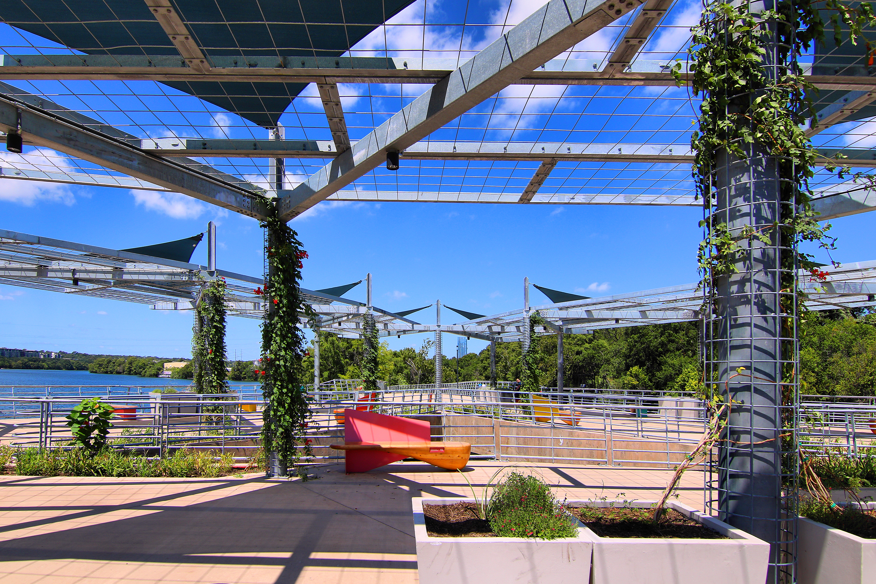 The planted shade structures of Wishbone Bridge beside Lady Bird Lake